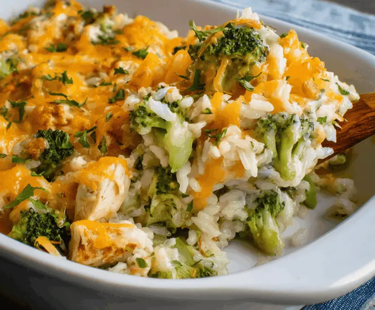 Delicious Chicken Broccoli Rice Casserole topped with melted cheese, ready to serve as a hearty and healthy dinner meal.