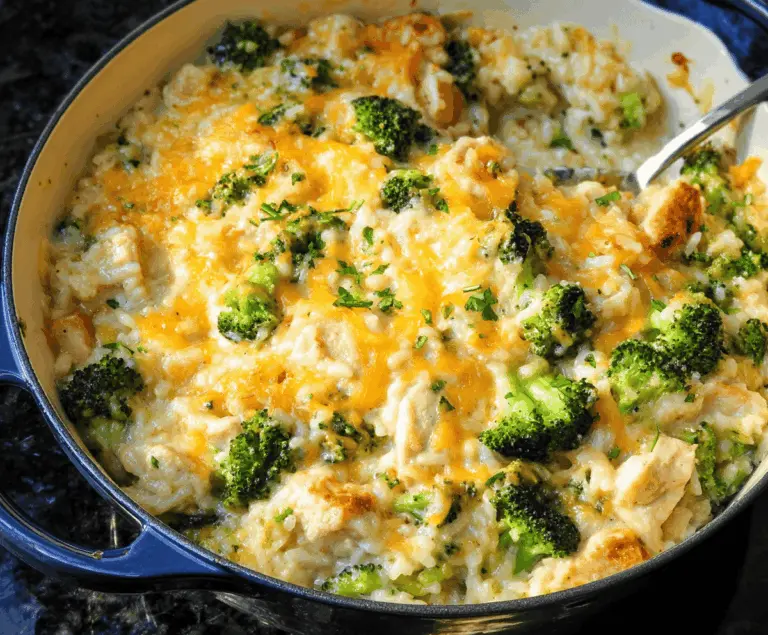 Delicious creamy chicken broccoli rice cheese casserole served in a baking dish, featuring golden melted cheese on top and fresh broccoli florets.