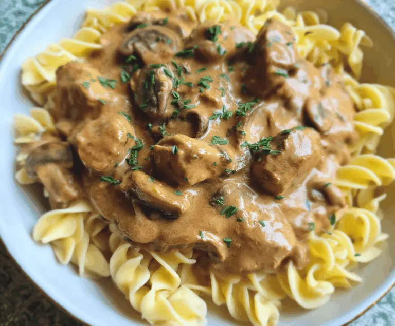Creamy mushroom and seitan stroganoff served in a bowl with fresh herbs, perfect for a hearty vegetarian meal