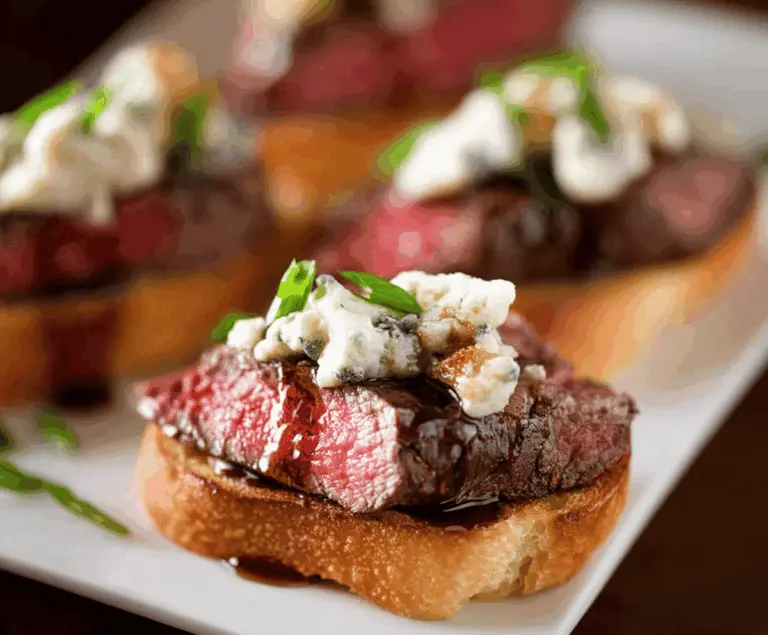 Delicious Beef Tenderloin Gorgonzola Crostini topped with creamy cheese and herbs, perfect for appetizers.