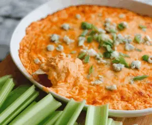 Creamy Buffalo Chicken Dip served with fresh vegetables and chips, perfect for parties and game day snacks