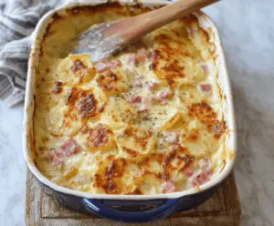 Delicious classic scalloped potatoes with ham served on a plate, perfect for comfort food lovers.