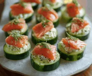 Delicious cucumber bites topped with smoked salmon and fresh herbs, perfect for appetizers.