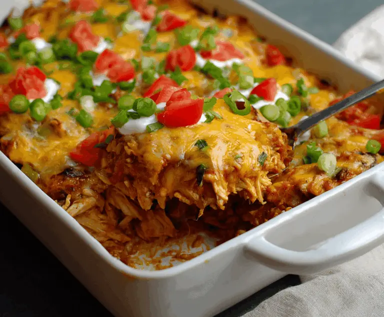 Delicious Healthy Chicken Taco Casserole with melted cheese and fresh toppings served in a baking dish
