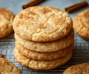 Delicious homemade Snickerdoodle Cookies dusted with cinnamon sugar on a rustic baking tray