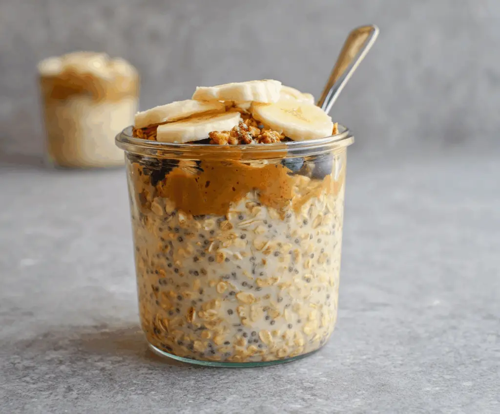 Delicious brown sugar overnight oats in a glass jar topped with fresh fruits and nuts.