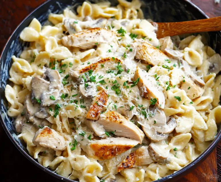 Creamy Chicken Alfredo pasta dish with tender chicken and rich Alfredo sauce on a white plate.