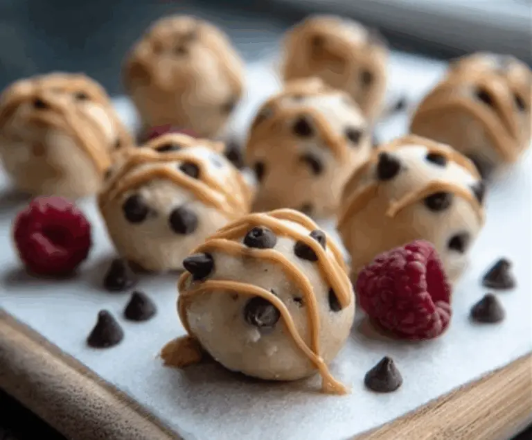 Frozen peanut butter yogurt bites on a white plate, showcasing creamy texture and chocolate drizzle, perfect for a healthy snack.