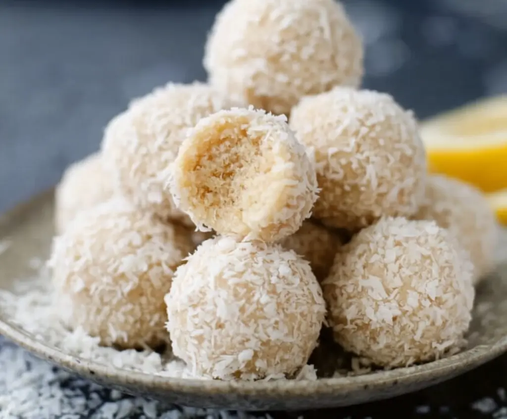Delicious lemon coconut protein balls on a white plate, perfect for a healthy snack