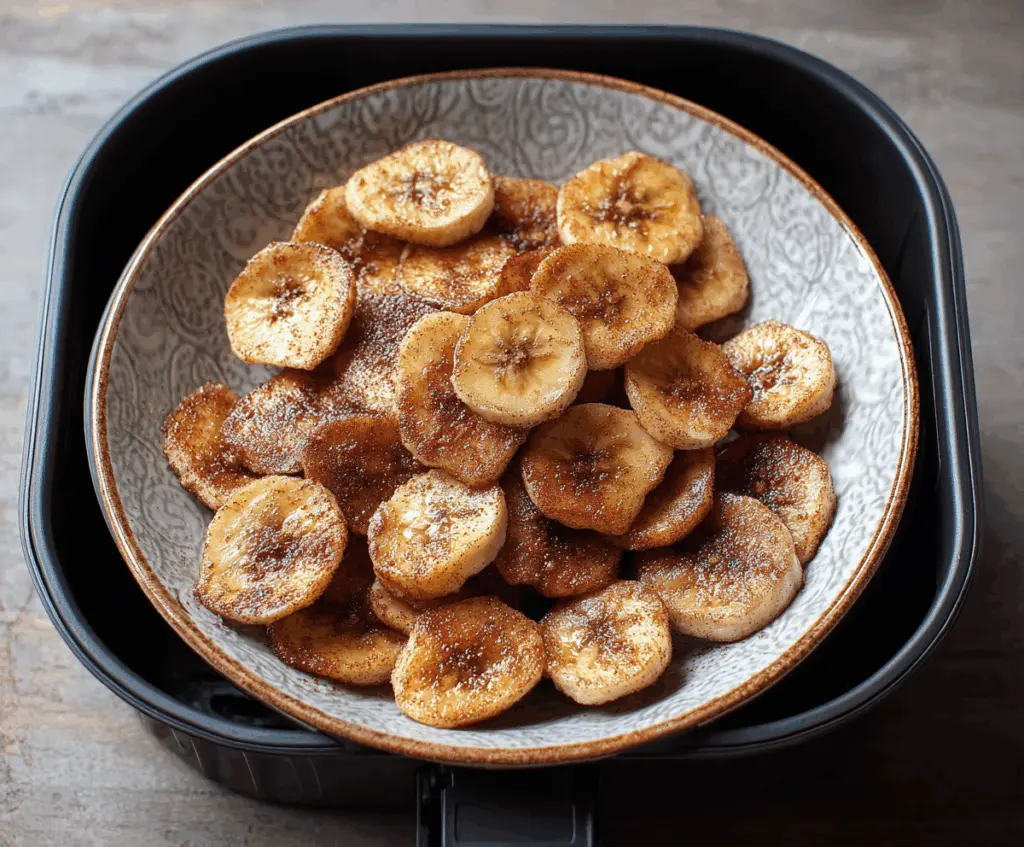 Crunchy air fryer cinnamon banana chips on a plate, healthy snack with cinnamon flavor