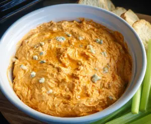 Creamy Crock Pot Buffalo Chicken Dip served with celery sticks and tortilla chips.