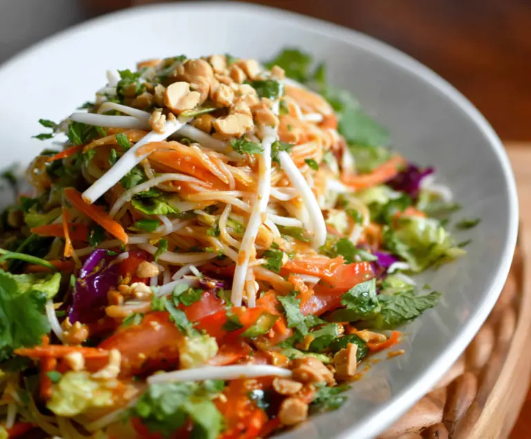 Fresh Spring Roll Salad with Peanut Dressing featuring colorful vegetables and crispy rolls.