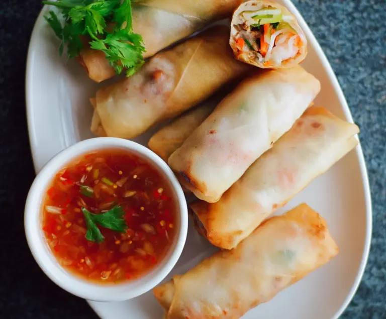 Fresh Thai spring rolls filled with colorful vegetables and herbs, served with a tangy dipping sauce.