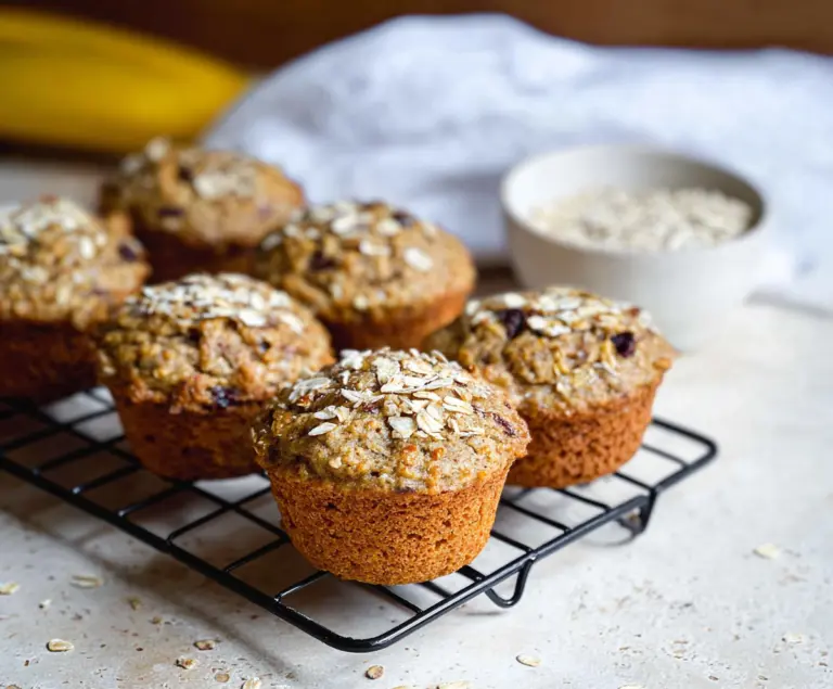 Healthy banana oatmeal muffins fresh out of the oven with golden crust and soft interior.