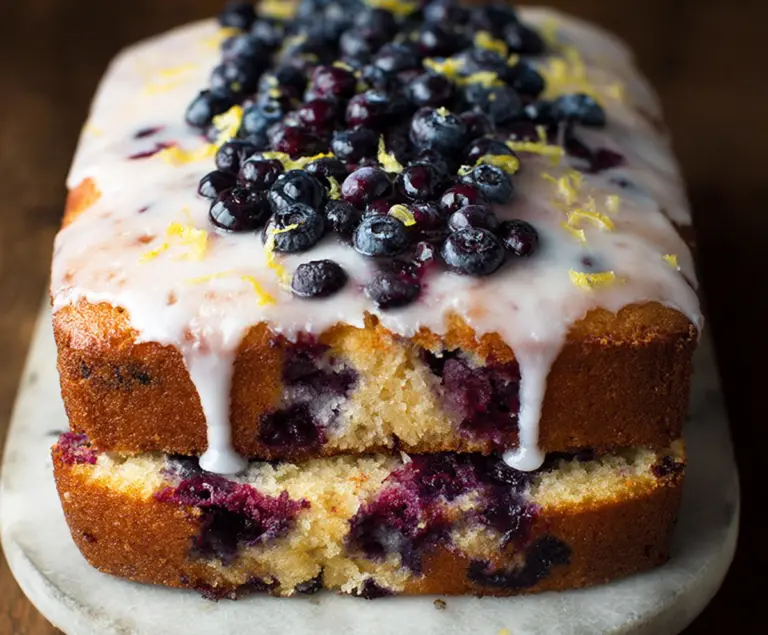 Delicious Lemon Blueberry Cake with fresh blueberries and lemon slices, perfect for summer desserts.